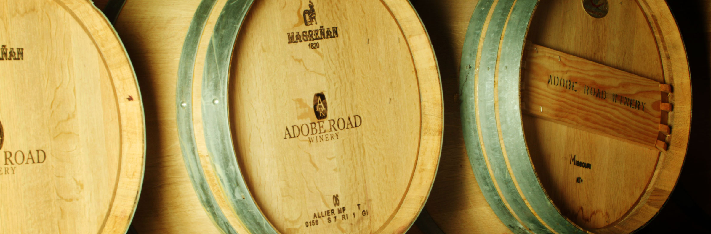 Three wine barrels with logo Adobe Road Winery